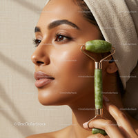 Young Asian Woman Using Jade Roller for Facial Massage and Skin Care