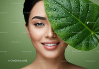 Young Woman with Fresh Skin and Tropical Leaf in Natural Setting