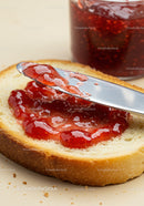 Spreading Fresh Strawberry Jam on Soft White Bread