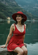Elegant Woman in Red Dress Smiling by Lake Outdoors