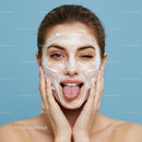 Young Woman Applying Facial Mask for Skincare Routine With Joyful Expression