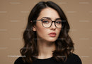 Elegant woman with glasses in studio portrait for fashion and beauty