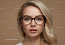 Stylish Blonde Woman Wearing Glasses in Indoor Studio Portrait