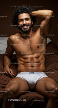Smiling muscular man relaxing on brown bedding in white briefs