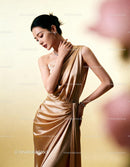 Elegant woman posing in silky golden evening gown