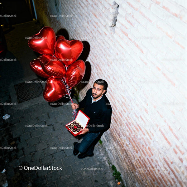 Man Holding Heart Balloons and Chocolate Box Outdoors