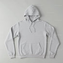 Minimalistic white hoodie laid flat on neutral background