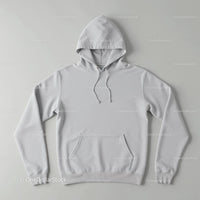 Minimalistic white hoodie laid flat on neutral background