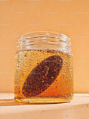 Close up of honey jar with lemon slice inside