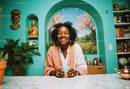 Happy Woman with Tea in Bright Cozy Living Room with Art and Decor