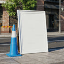 Blank outdoor sandwich board with blue traffic cone