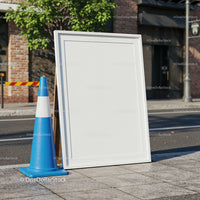 Blank outdoor sandwich board with blue traffic cone
