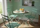 Cozy breakfast nook with pastel green furniture and sunlight