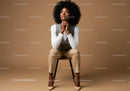 Stylish Confident Woman Sitting on Chair in Modern Studio