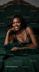 Smiling woman relaxing in black lace lingerie on bed