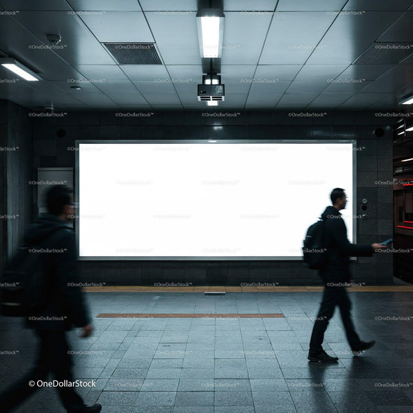 Commuters walking past bright billboard in underground station JPG Mockup Image