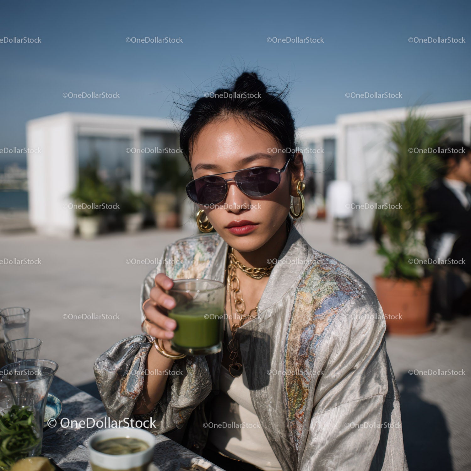 Stylish Woman Drinking Green Juice on Rooftop in Summer