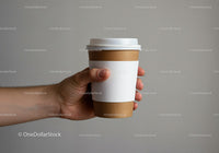 Hand Holding Takeaway Coffee Cup with Blank Sleeve