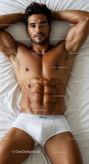 Fit man relaxing on bed wearing white underwear