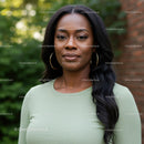 Confident woman standing outdoors with serene expression