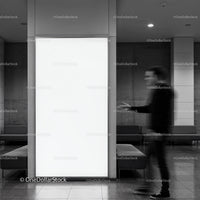 Blurred man walking past bright blank advertising panel