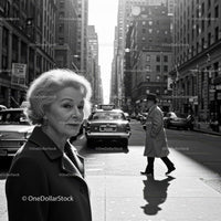 Elegant Elderly Woman Walking in Black and White City Street Scene
