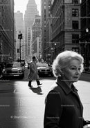 Elegant Elderly Woman Walking in Busy City Street in Black and White
