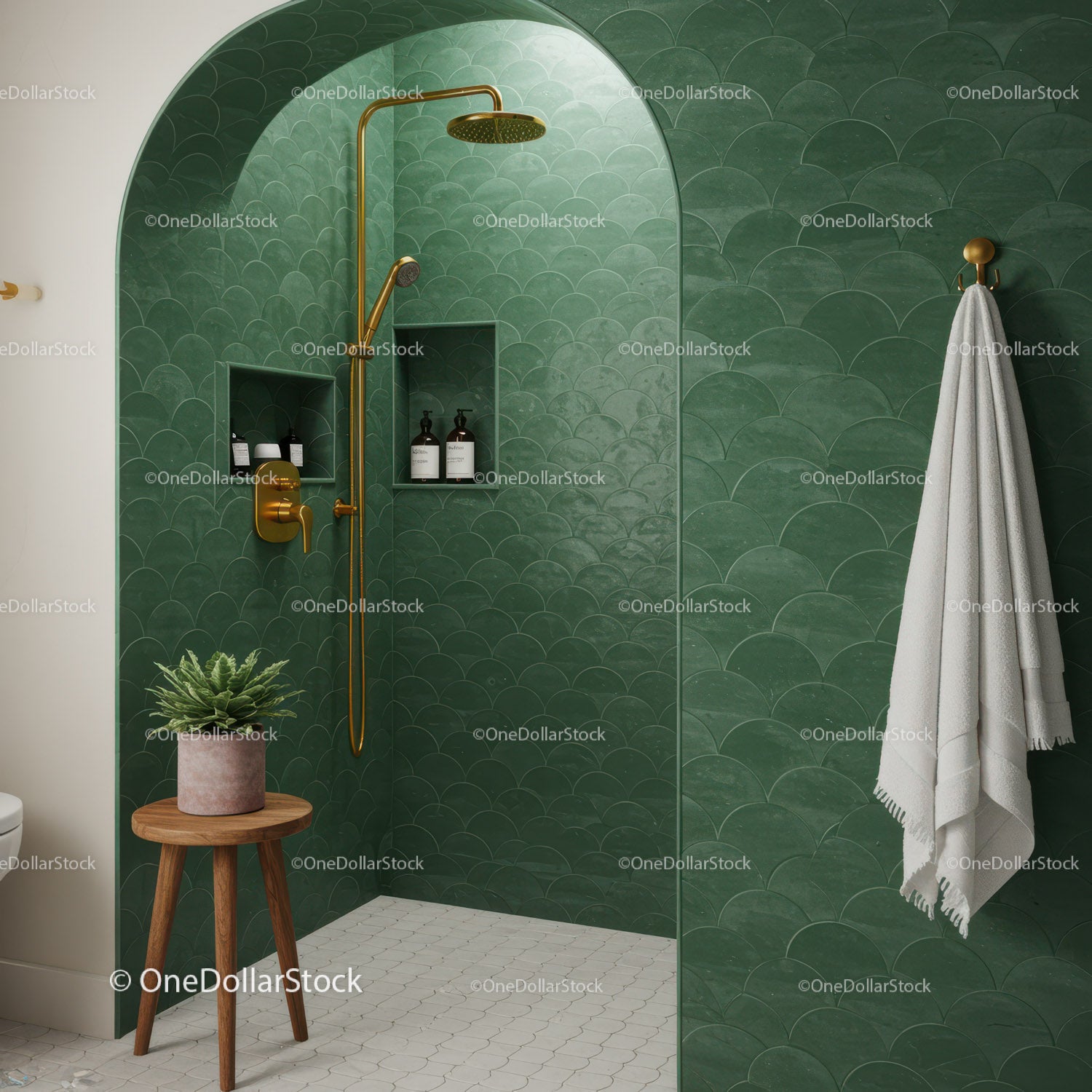 Modern green tiled shower with gold fixtures and plant