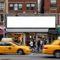 Yellow taxis passing by busy city clothing store