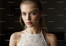 Young Woman in Lace Top with Elegant Style and Captivating Gaze