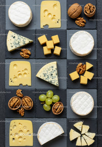 Assorted gourmet cheeses with walnuts and grapes
