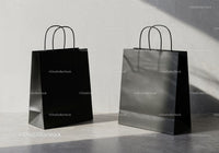 Minimalistic black shopping bags on concrete floor