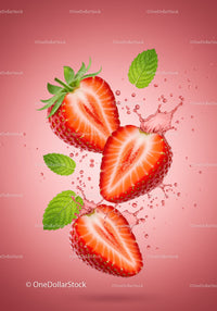 Fresh strawberry halves with mint leaves and splashes