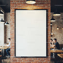 Blank poster frame on brick wall in modern cafe interior