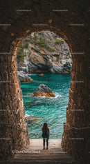 Woman with Backpack Exploring Turquoise Coastal Rock Formation and Sea