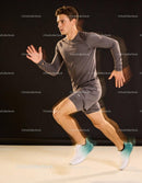 Focused young male sprinter training indoors in motion