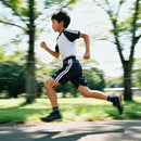 Young Boy Running Energetically in Sunny Park