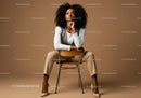 Confident Woman Sitting on Chair in Neutral Fashion Photo