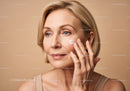 Elegant Mature Woman Applying Skincare Cream