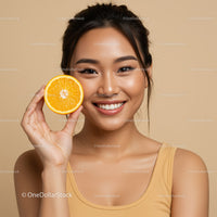 Joyful Woman with Orange Slice in Bright Studio Portrait