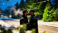 Couple Sharing a Tender Kiss on Snowy Winter Evening