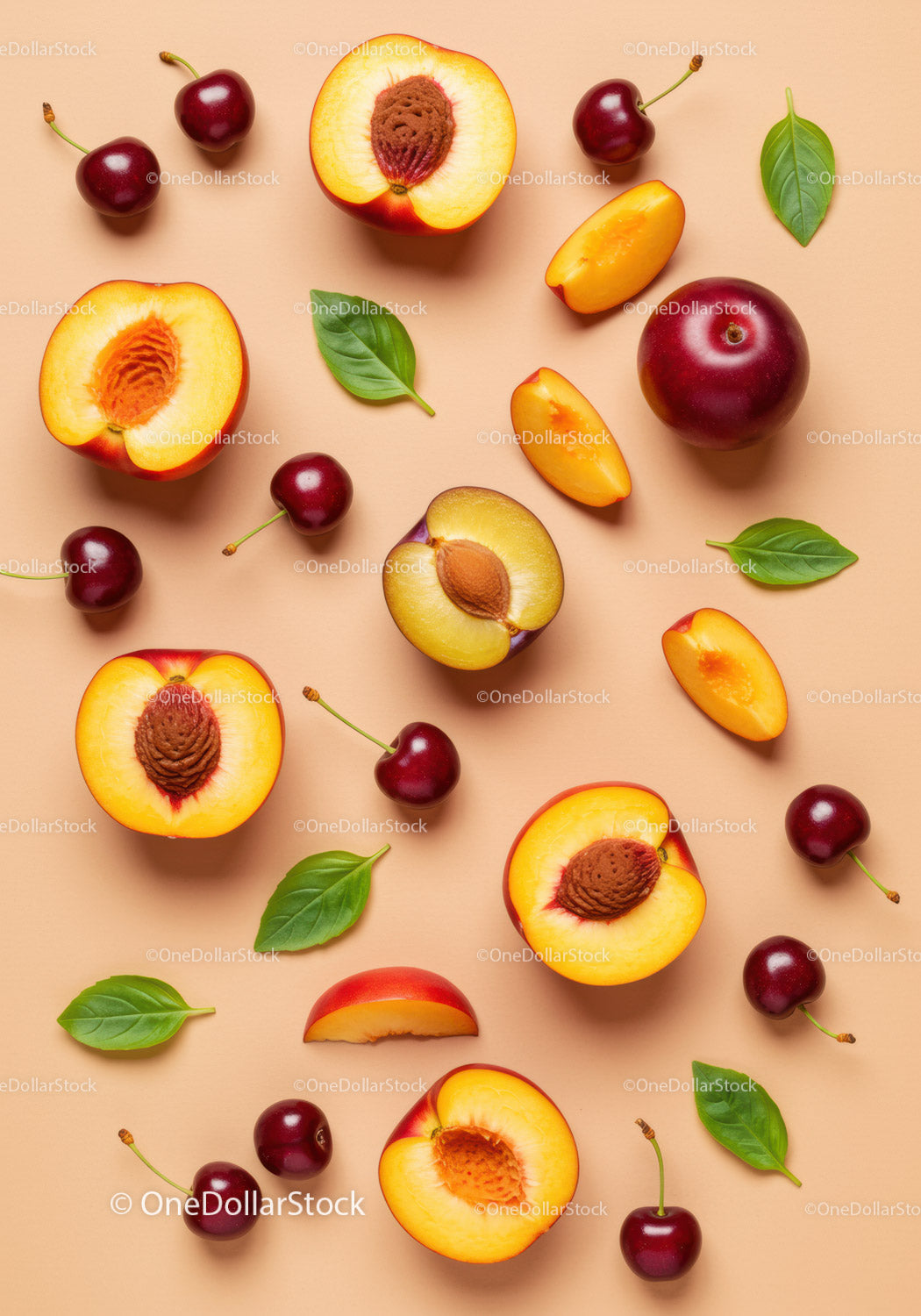 Fresh peaches and cherries with green leaves on beige