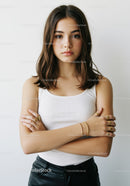 Confident Young Woman in White Tank Top and Leather Pants