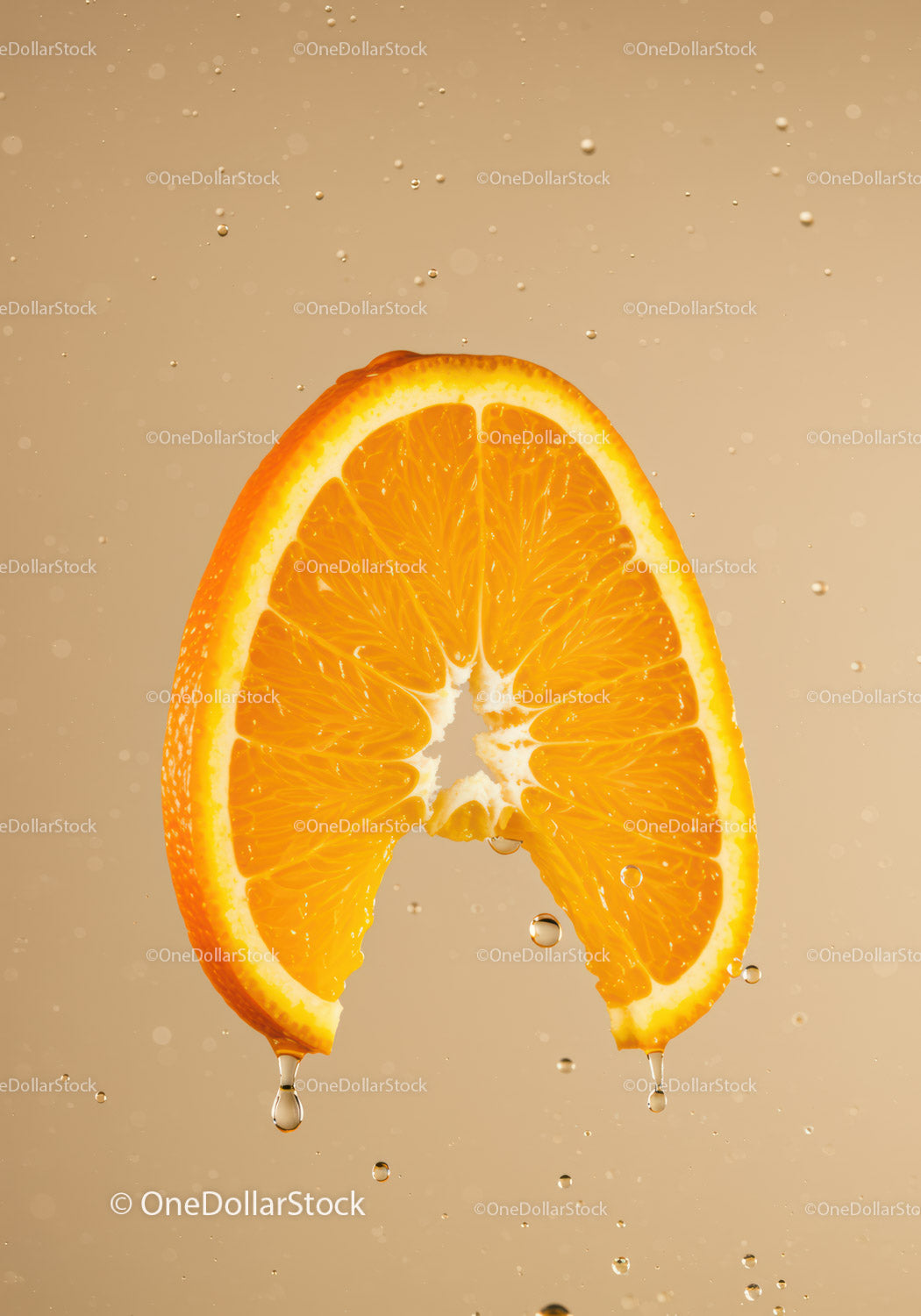 Juicy orange slice with water droplets on beige background