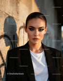 Confident woman with bold makeup in urban sunlight