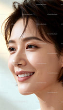 Close-up portrait of a smiling young woman with glowing skin