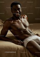 Smiling man relaxing on bed in white underwear