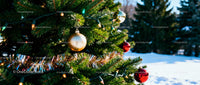 Outdoor Christmas tree decorated with shiny baubles