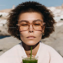 Young Woman Wearing Stylish Sunglasses Drinking Green Smoothie Outdoors