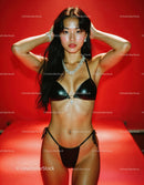 Glamorous Young Woman in Black Bikini with Jewelry on Red Background